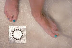 bare feet with colorful nail polish in the bathroom