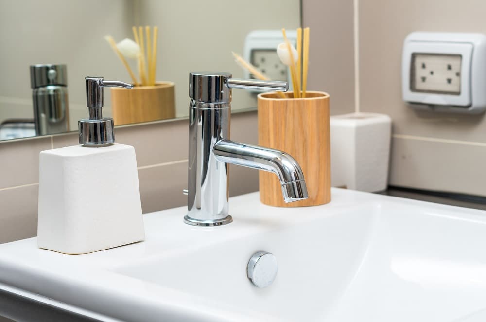 Chrome faucet with washbasin in modern bathroom