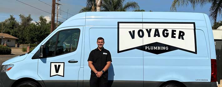 Voyager Plumbing branded vehicles lined up for service