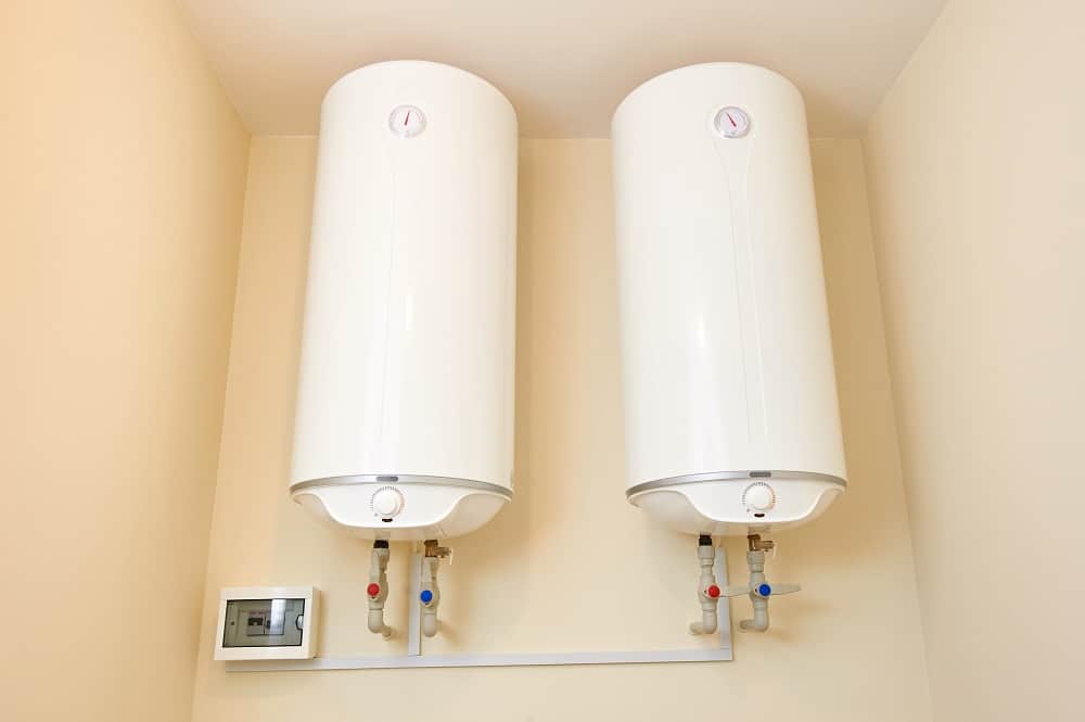 Two electric water heaters on the wall. Home wall mounted two water heating boilers. No people.