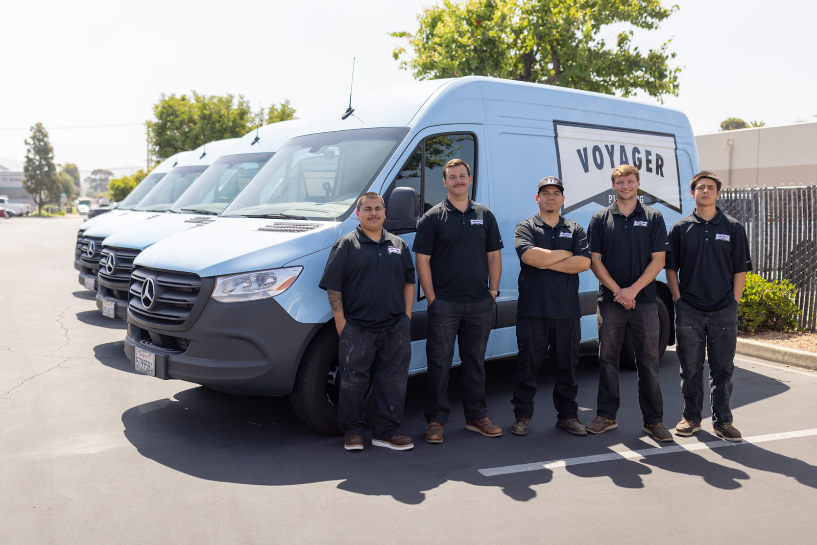 Voyager team of plumbers by service trucks