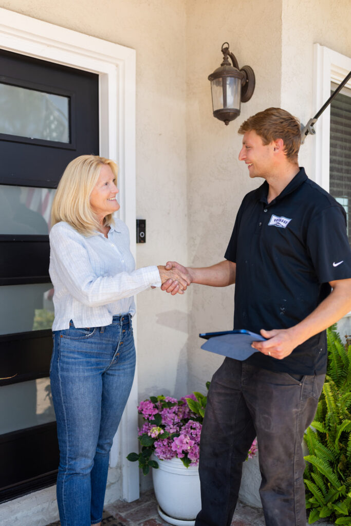 Customer buying plumbing services from Voyager Employee