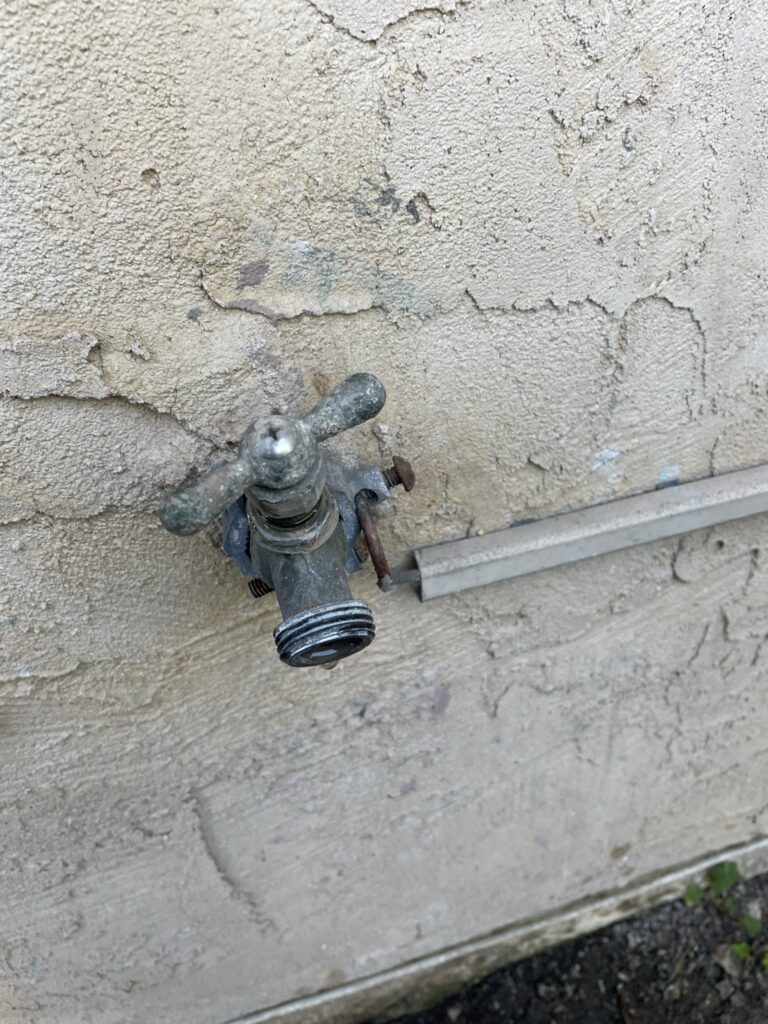 old dripping outdoor faucet